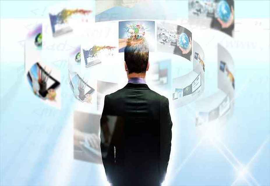 A man in a suit stands facing a curved virtual display with multiple floating screens in a bright, futuristic setting, showcasing strategies for social media recruitment and job advertisement optimization.