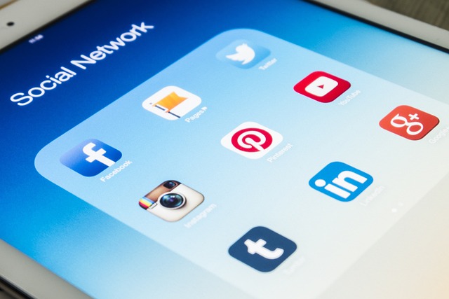 An iPad screen displays a folder labeled Social Network containing app icons for Facebook, Instagram, Twitter, Pinterest, Tumblr, LinkedIn, YouTube, and Google+, all essential tools for effective Marketing Analytics and targeted promotions.