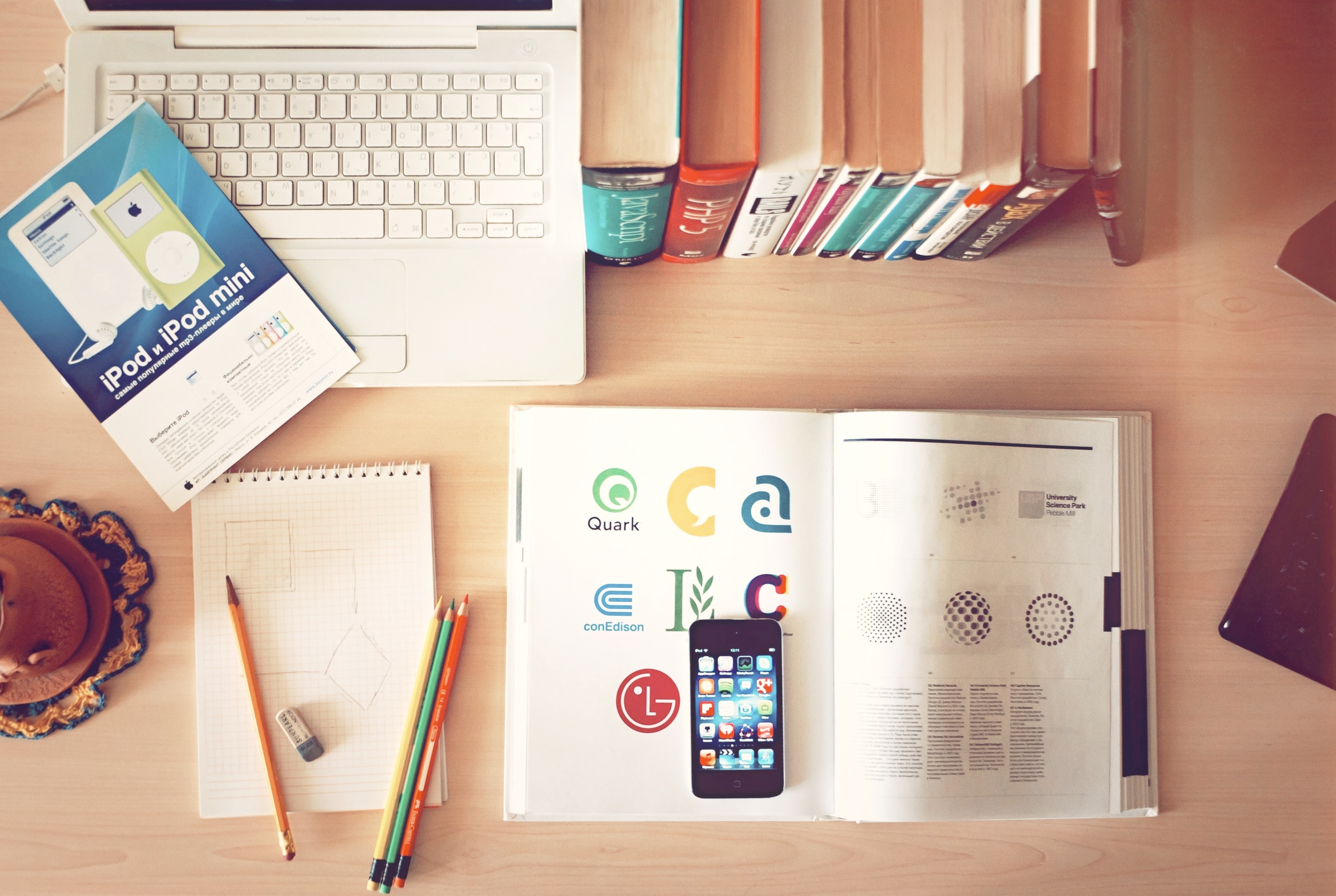 A cluttered desk with a computer displaying analytical data on Email Marketing ROI, a cup of steaming coffee, office supplies, a lamp, and charts in the background.